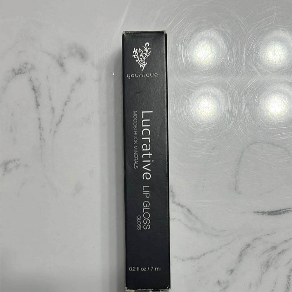 Younique Lucrative Lip Gloss -shade is Livid. New in box